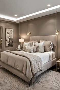 a large bed sitting in a bedroom next to two lamps