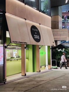 a man walking down the sidewalk in front of a store