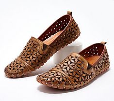 Go ahead and kick up your style! When it comes to comfy-chic style, these perforated floral slip-ons are a cut above the rest. From Spring Step. Brown Flat Slip-ons For Spring, Brown Slip-ons For Spring, Spring Flat Heel Slip-ons With Perforations, Comfortable Brown Slip-ons For Spring, Spring Perforated Flat Heel Slip-ons, Spring Slip-ons With Perforations And Flat Heel, Spring Flat Slip-ons With Perforations, Comfortable Leather Slip-ons For Spring, Casual Perforated Slip-ons For Spring