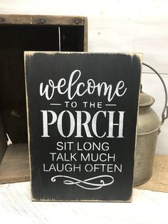 a wooden sign that says welcome to the porch