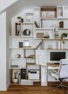 a white chair sitting in front of a computer desk