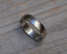 a silver ring sitting on top of a wooden table