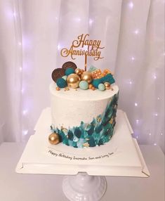 a white cake with blue and gold decorations