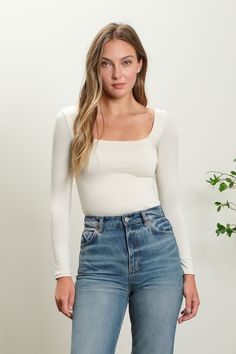 The Seamless Square Neck Bodysuit is a sleek and versatile staple that offers a smooth, streamlined silhouette, perfect for layering or wearing as a stand-alone piece. Featuring a square neckline, this bodysuit provides a modern and elegant touch that frames the collarbone and highlights the neck area, making it an excellent choice for showcasing statement jewelry or layering under low-cut garments. Crafted from a blend of materials that typically include spandex or elastane, the seamless design Seamless Bodysuit, Square Neck Long Sleeve, Square Neck Bodysuit, White Bodysuit, White Square, Kimono Jacket, Dressy Tops, Off White Color, New Tops