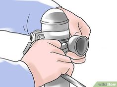 a person holding a metal object in their hand and pointing it at the camera lens