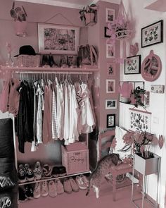 a room with pink walls and pictures on the wall, including clothes hanging from racks