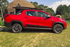 a red pick up truck parked in the grass