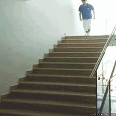 the man is walking down the stairs with an umbrella