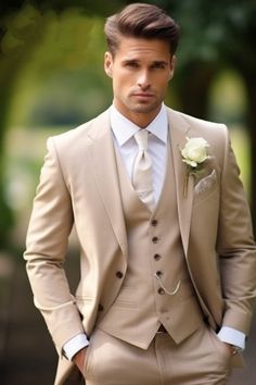 a man in a tan suit with a white boutonniere and a flower on his lapel