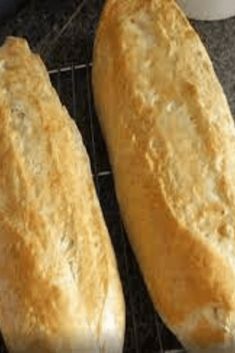 two loafs of bread cooling on a rack