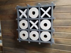 a tic - tac - toe board mounted to the side of a wooden wall