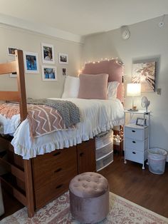 a bedroom with a bed, dresser and ottoman