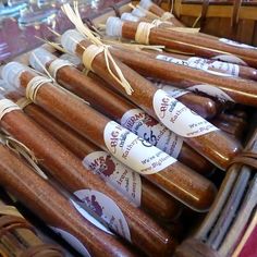 several sausages are on display in a basket at a food stand with price tags attached to them