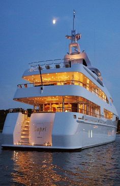 a large white boat in the water at night