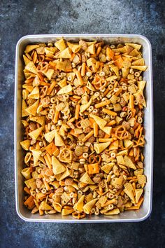 a casserole dish filled with cheetos and nuts