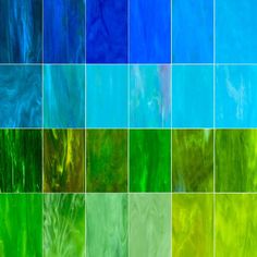 many different colors of glass tiles in various sizes and shapes, including blue, green, yellow