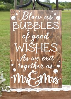 a wooden sign that says blow us bubbles of good wishes as we exit together as mr and mrs