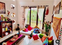 a living room filled with lots of colorful pillows