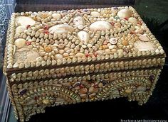 an elaborately decorated box with shells on it