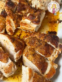 some chicken is sitting on a plate with seasoning sprinkled around the edges