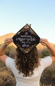 a woman wearing a graduation cap with writing on it