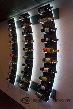 a wall mounted wine rack filled with lots of bottles