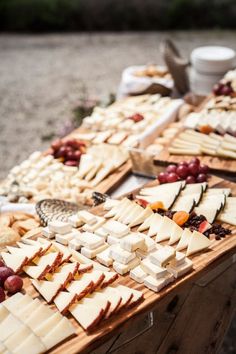 cheeses and grapes are laid out on a table