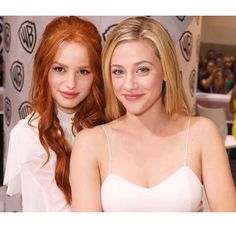 two beautiful young women sitting next to each other