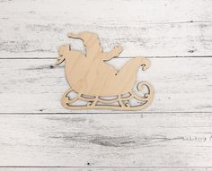 a wooden rocking horse ornament on a white wood background