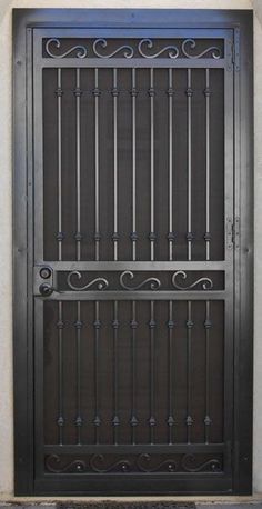 an iron gate is shown on the side of a building's front door,