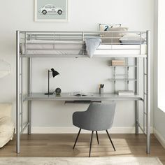 a loft bed with desk underneath it in a white room next to a couch and chair