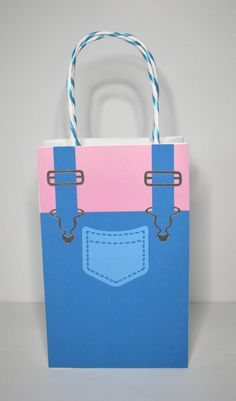 a blue and pink paper bag with handles