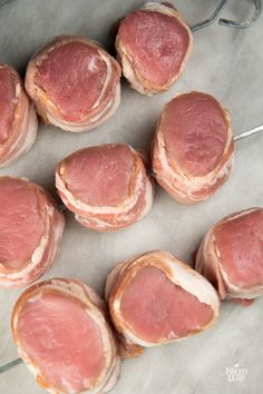 some raw meats are on a tray ready to be cooked