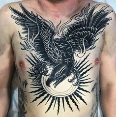 a man's chest with an eagle tattoo on it