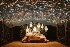 an outdoor covered area with lights and decorations