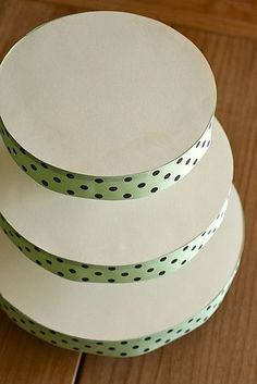 three white plates stacked on top of each other with polka dot trim around the edges