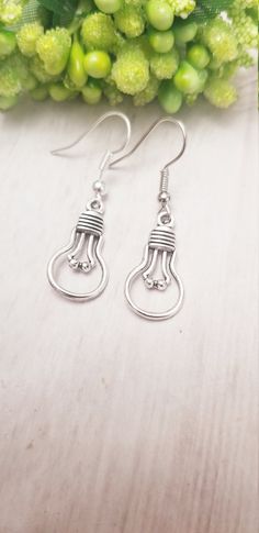 This unique and dainty Light Bulb earrings is made with a high-quality material that is eco-friendly, durable, and anti-inflammatory. It won't leave your skin green due to marks. Product Details: - Material:Silver earring hook - Charms:Light Bulb charms. These earrings are made using high-quality and non-toxic silver metal that is hypoallergenic and gentle on the skin. The quality is top-notch to protect your ears from any kind of inflammation or skin allergy. These earrings with a charm can empower you in unlimited ways, making you feel confident, bold, and beautiful in your apparel. You can wear this quirky design to any casual or formal event like Christmas, weekend parties, friends' meetups, Valentine's Day, etc. If you are looking for a special gift for your beloved lady on her birthd Urban Street Fashion, Kpop Earrings, Street Mode, Skin Allergy, Weekend Party, Earring Hook, Skin Allergies, Urban Street Style, Urban Street