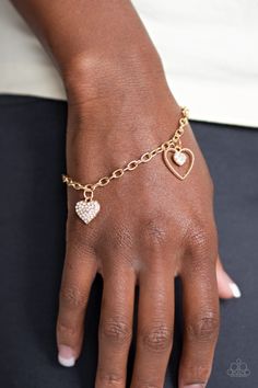 A charming collection of gold hearts and white rhinestone encrusted heart frames dangle from a glistening gold chain, creating a flirtatious fringe around the wrist. Features an adjustable clasp closure. Sold as one individual bracelet. P9RE-GDXX-264XX Paparazzi Accessories Jewelry, Valentines Bracelets, Feeling Pretty, Gold Hearts, Perfume Gift, Heart Frame, Jewelry Show, Rock Stars, Unique Bracelets