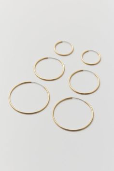 Set of three pairs of classic hoop earrings in 18k gold-plated or sterling silver-plated finishes. Endless hoop closure. Content + Care Set of 3 pairs 80% Brass, 15% stainless steel, u00a05% real gold or silver platingu00a0u00a0 Avoid contact with water Imported Size Dimensions: 1.5" , 1.25" , 0.75" u00a0dia | 18k Gold & Sterling Silver Plated Hoop Earring Set in Gold, Women's at Urban Outfitters Urban Outfitters Hoop Jewelry, Elegant Everyday Jewelry From Urban Outfitters, Elegant Everyday Jewelry By Urban Outfitters, Elegant Gold Jewelry From Urban Outfitters, Elegant Gold Urban Outfitters Jewelry, Urban Outfitters Gold Jewelry For Gift, Urban Outfitters Gold Jewelry For Gifts, Hoop Earring Set, Hoop Earring Sets