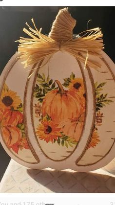 a painted pumpkin with sunflowers on it