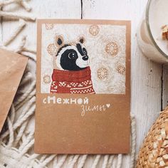 a card with an image of a panda bear wearing a sweater on top of it