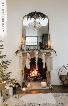 three children sitting on the floor in front of a fire place with stockings hanging over it