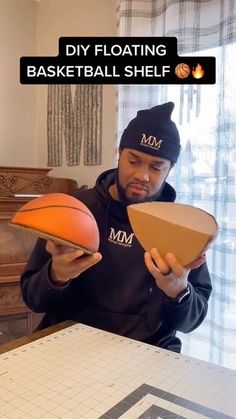 a man holding a basketball in front of his face with the text diy floating basketball shelf