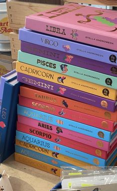 a stack of children's books sitting on top of a wooden crate next to other boxes