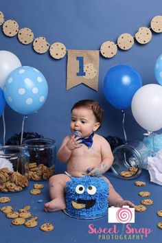 a baby is sitting in front of some cookies