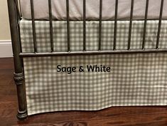 a black and white checkered crib with the name sage & white on it