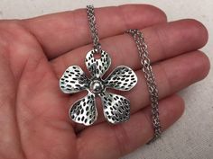 "Big, bold and unique silver flower pendant necklace. simple, refined and eye catching. It has incredible detail and design. The perfect everyday necklace for any nature lover. The pendant measures 1 3/8\" long by 1 3/8\" wide and made from allergy free plated silver. It hangs from a simple shiny 18\" stainless steel necklace chain with a lobster clasp. I have matching earrings in my shop if you would like the whole set. Here is a direct link https://etsy.me/37xz8Ql Thanks for stopping by! Pleas Metal Flower Charm Necklaces, Metal Flower Necklace For Gift, Handmade Silver Flower Necklace, Silver Flower Shaped Metal Necklace, Silver Flower-shaped Metal Necklace, Silver Metal Flower Pendant Necklace, Silver Metal Pendant Flower Necklace, Silver Flower Pendant Necklace, Boho Hoop Earrings