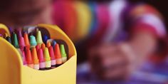 a child is drawing with colored crayons in a yellow container and the title tips for parents how to spoil children the right way