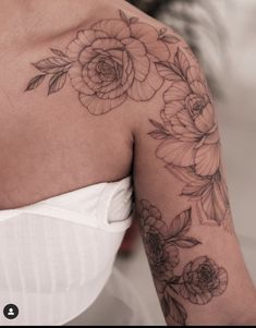 a woman's arm with flowers on it