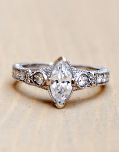 a close up of a diamond ring on a table